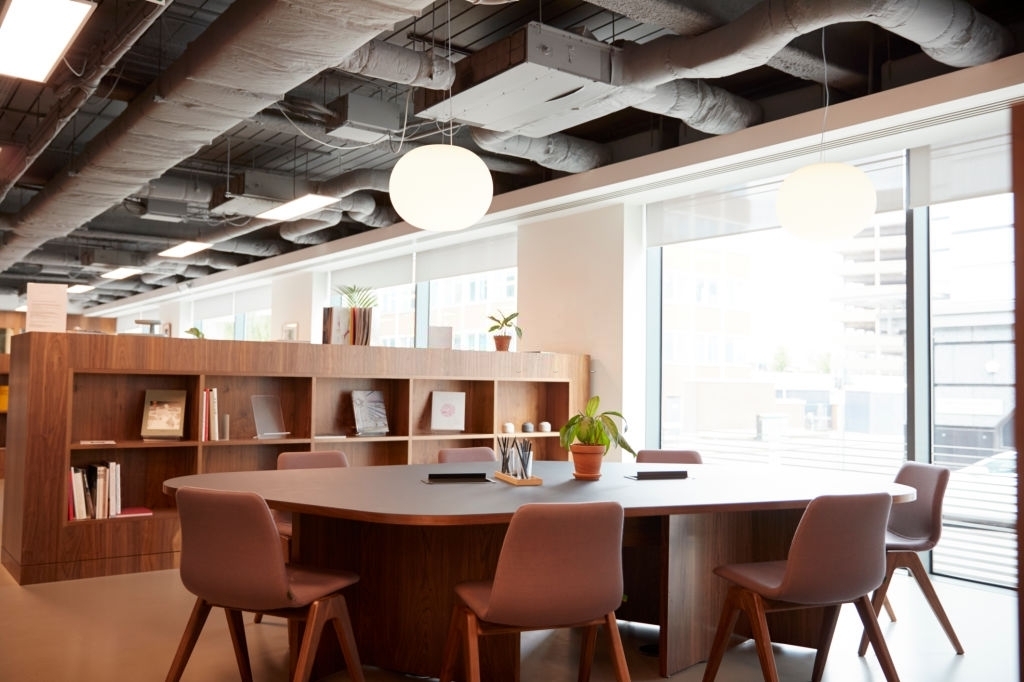 Brown Conference Table Inside Decorative Office Building With Open Ceiling Concept