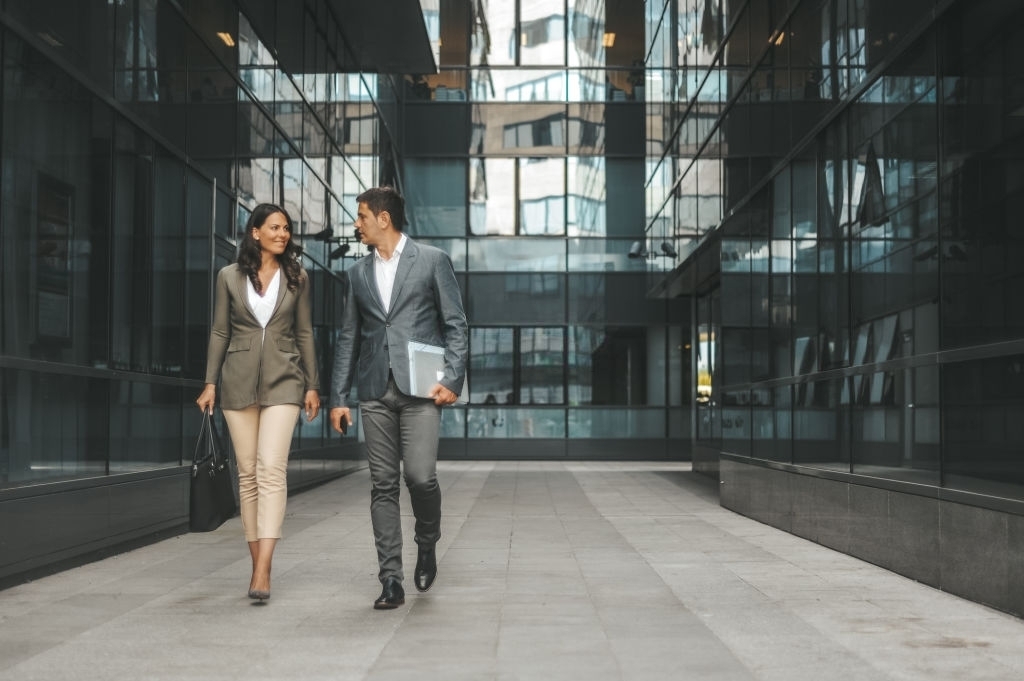 Business Woman and Business Man Walk Outside Through Office Buildings