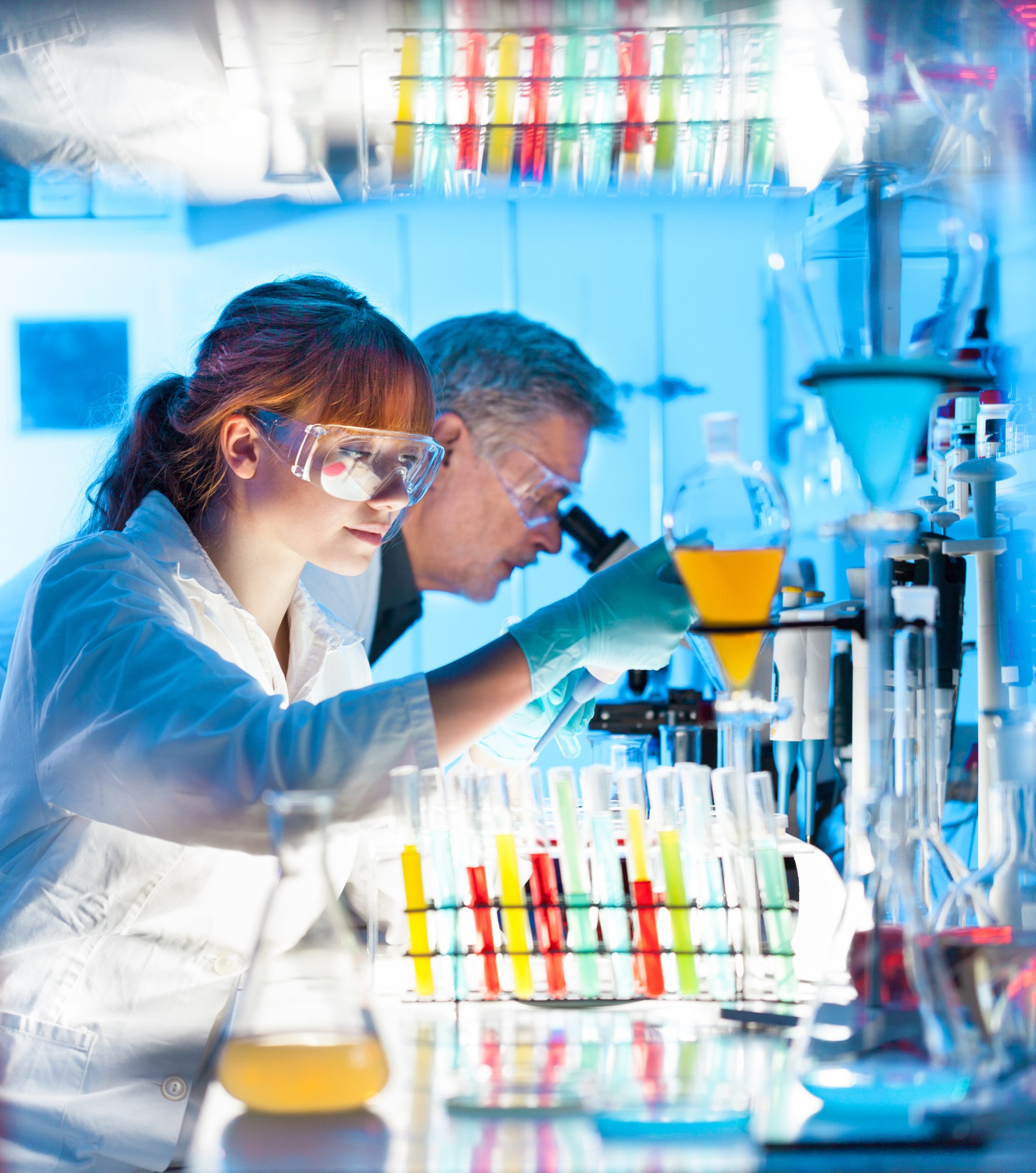 Young,Female,Scientist,And,Her,Senior,Male,Supervisor,Pipetting