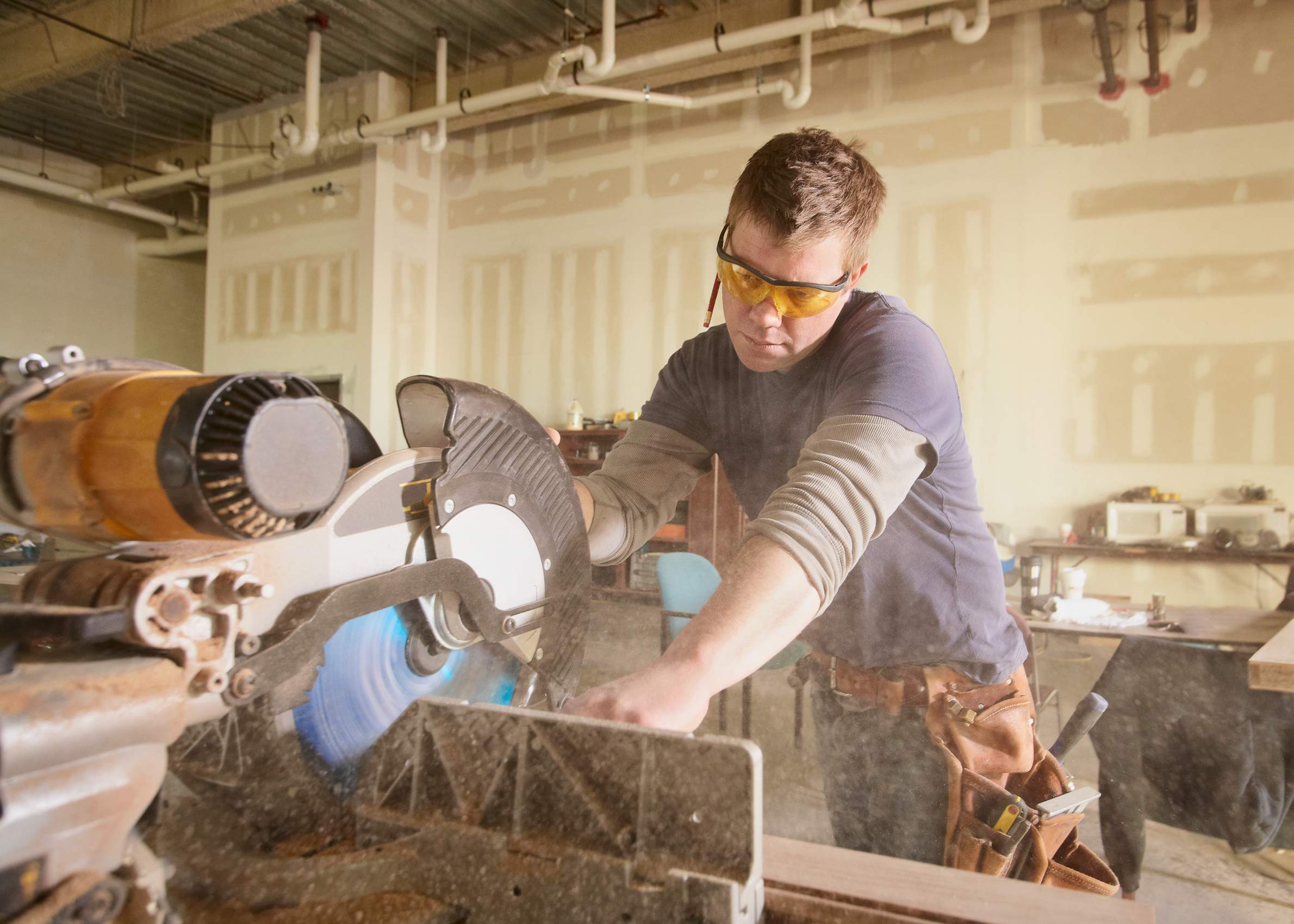 Carpenter,At,Work,On,Job,Using,Power,Tool