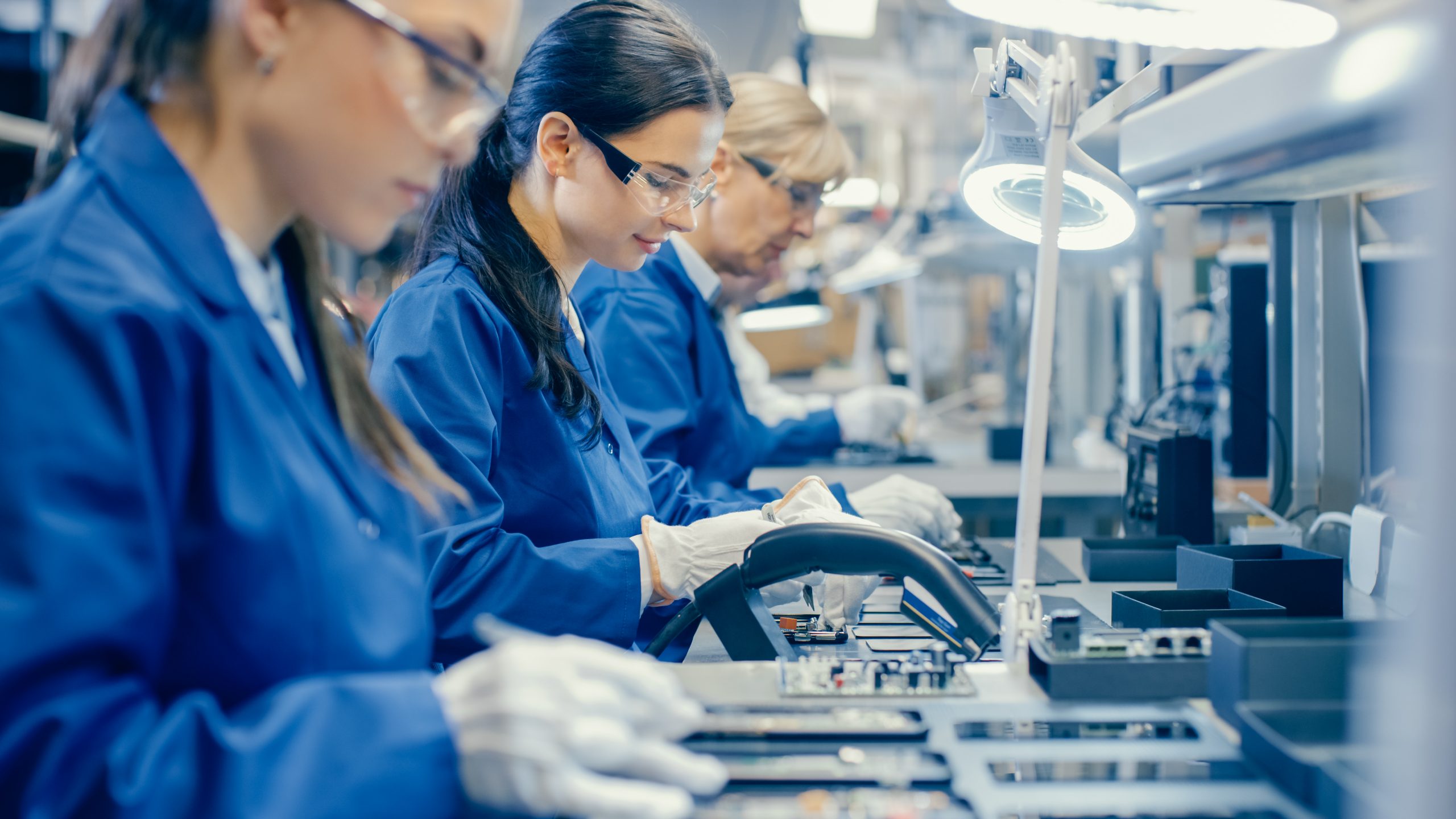 Female,Electronics,Factory,Workers,In,Blue,Work,Coat,And,Protective