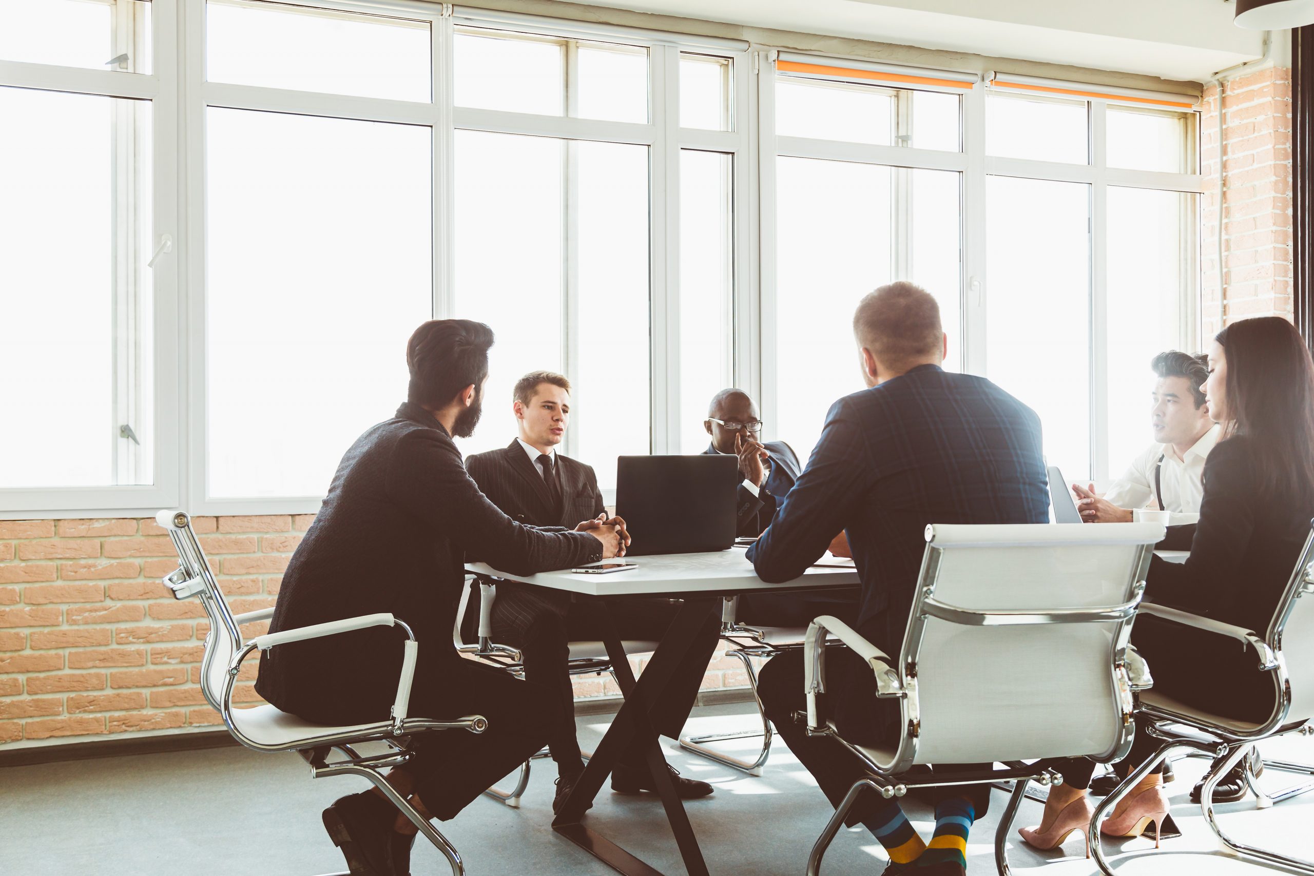 Group,Of,Young,Business,People,Working,And,Communicating,While,Sitting