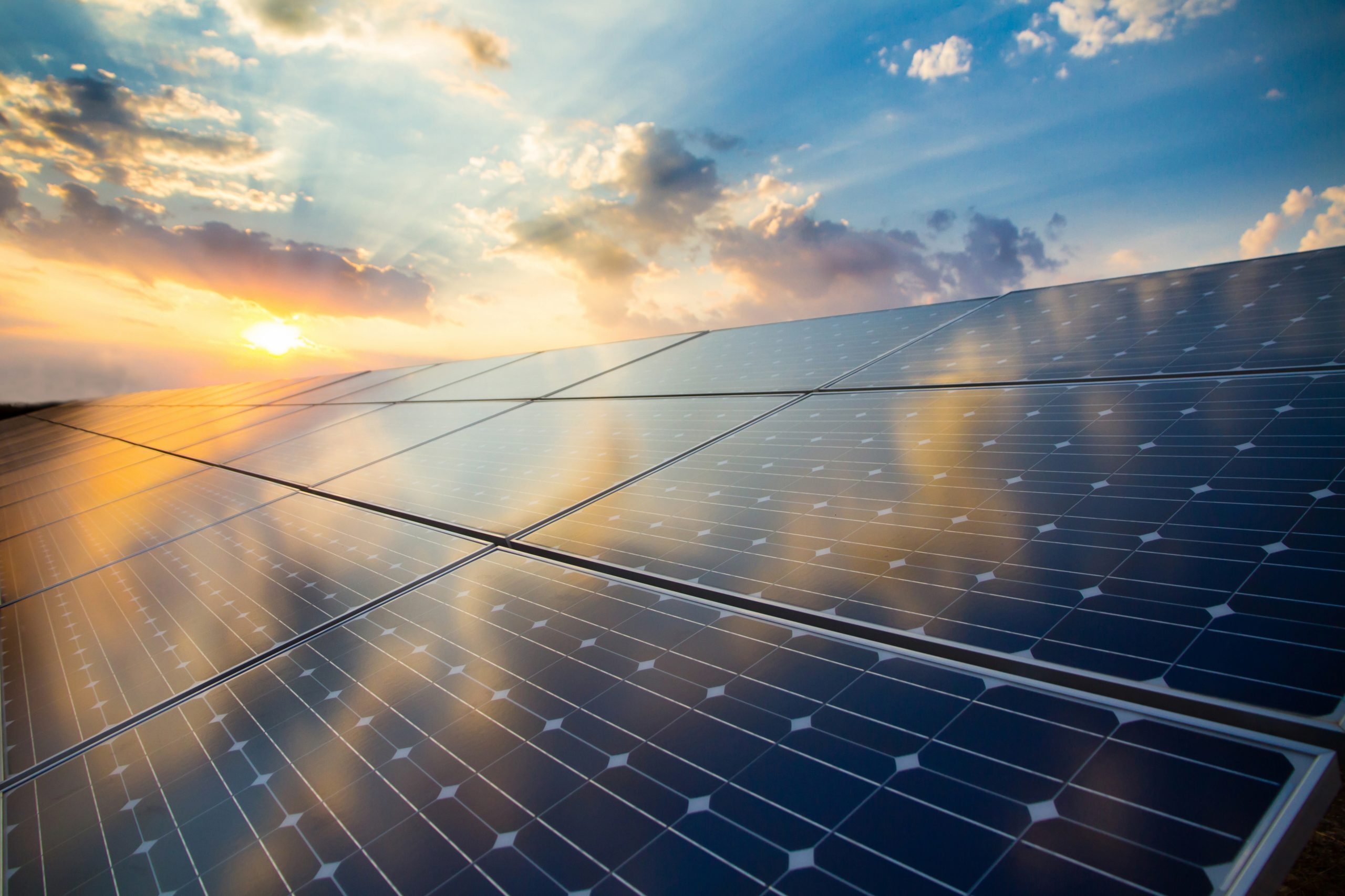 Photovoltaic,Modules,On,The,Background,Of,Sunset,And,Cloudy,Sky