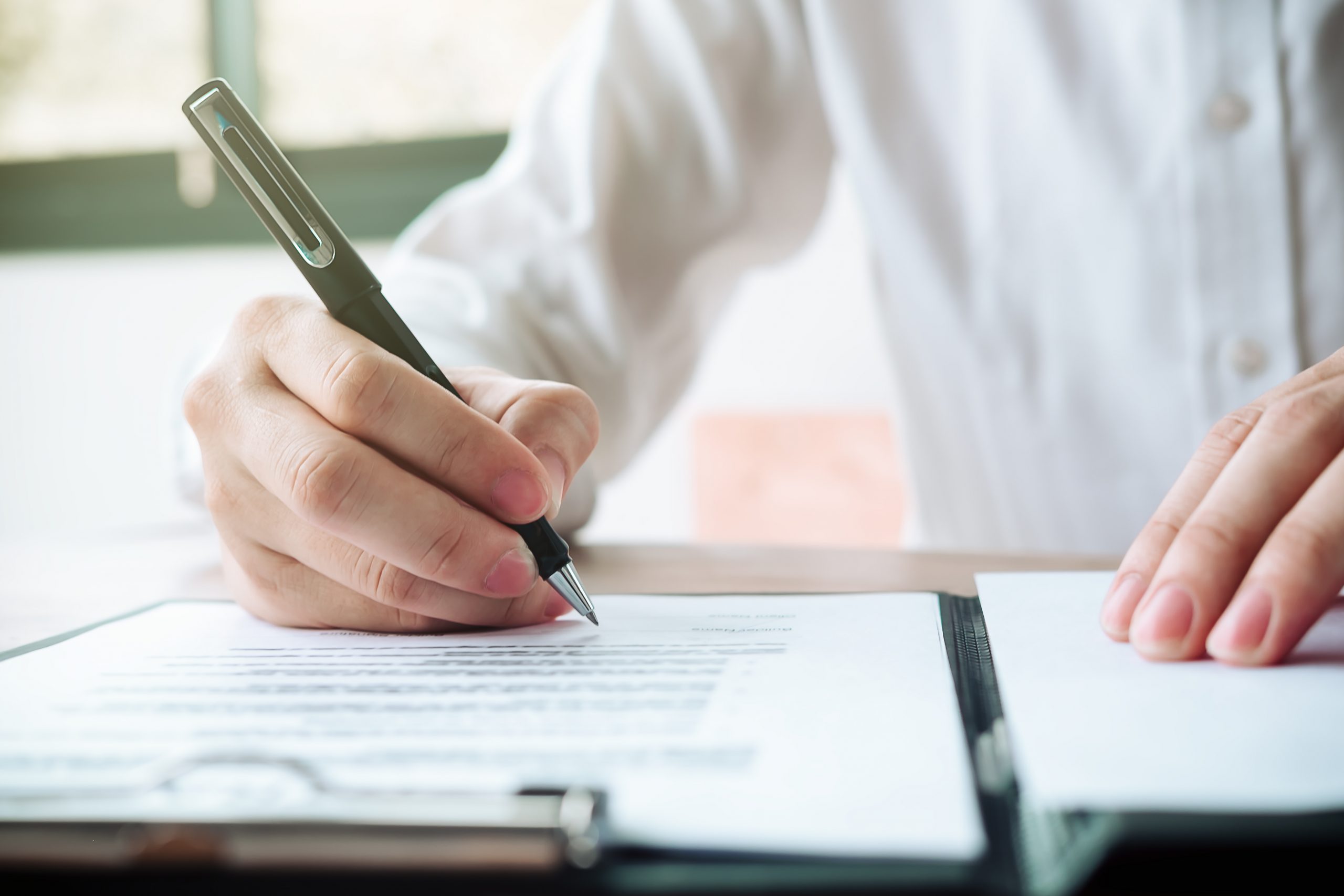 Close,Up,Business,Man,Reaching,Out,Sheet,With,Contract,Agreement