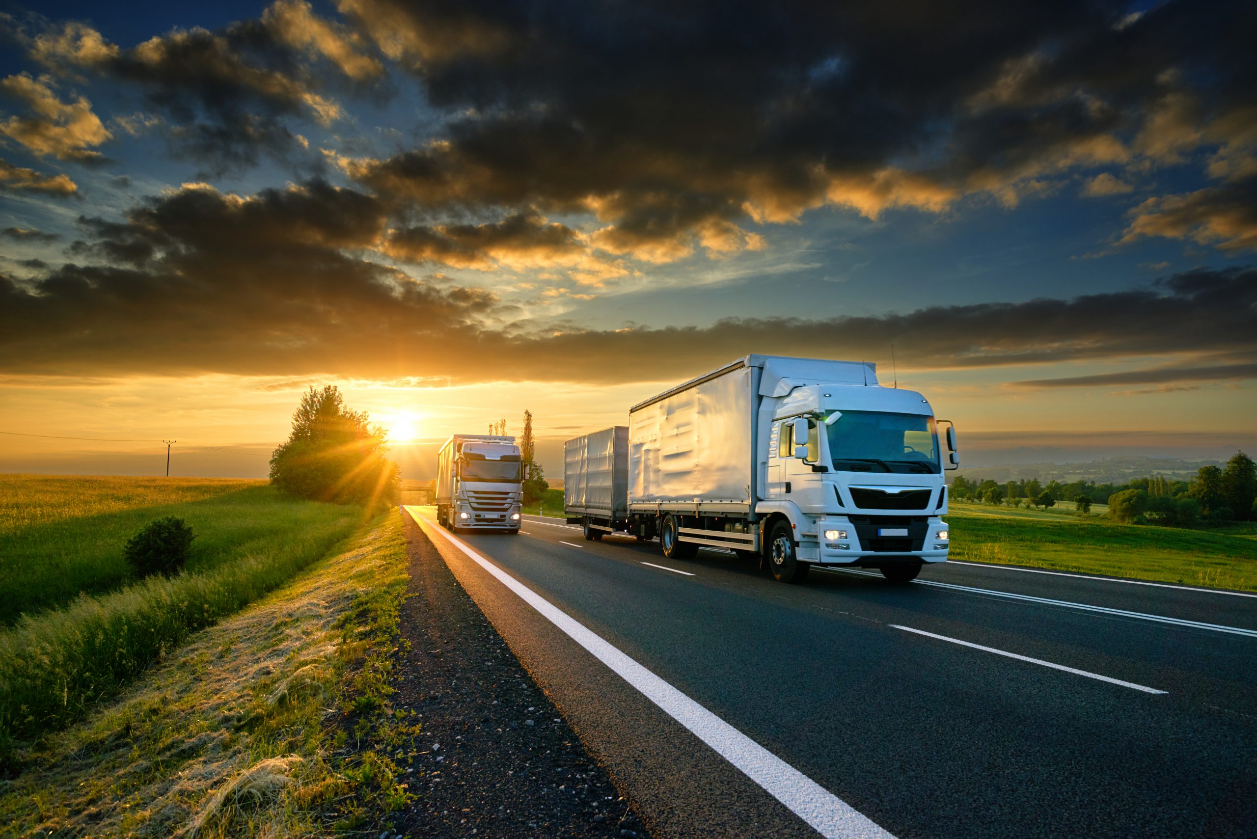 Overtaking,Trucks,On,An,Asphalt,Road,In,A,Rural,Landscape