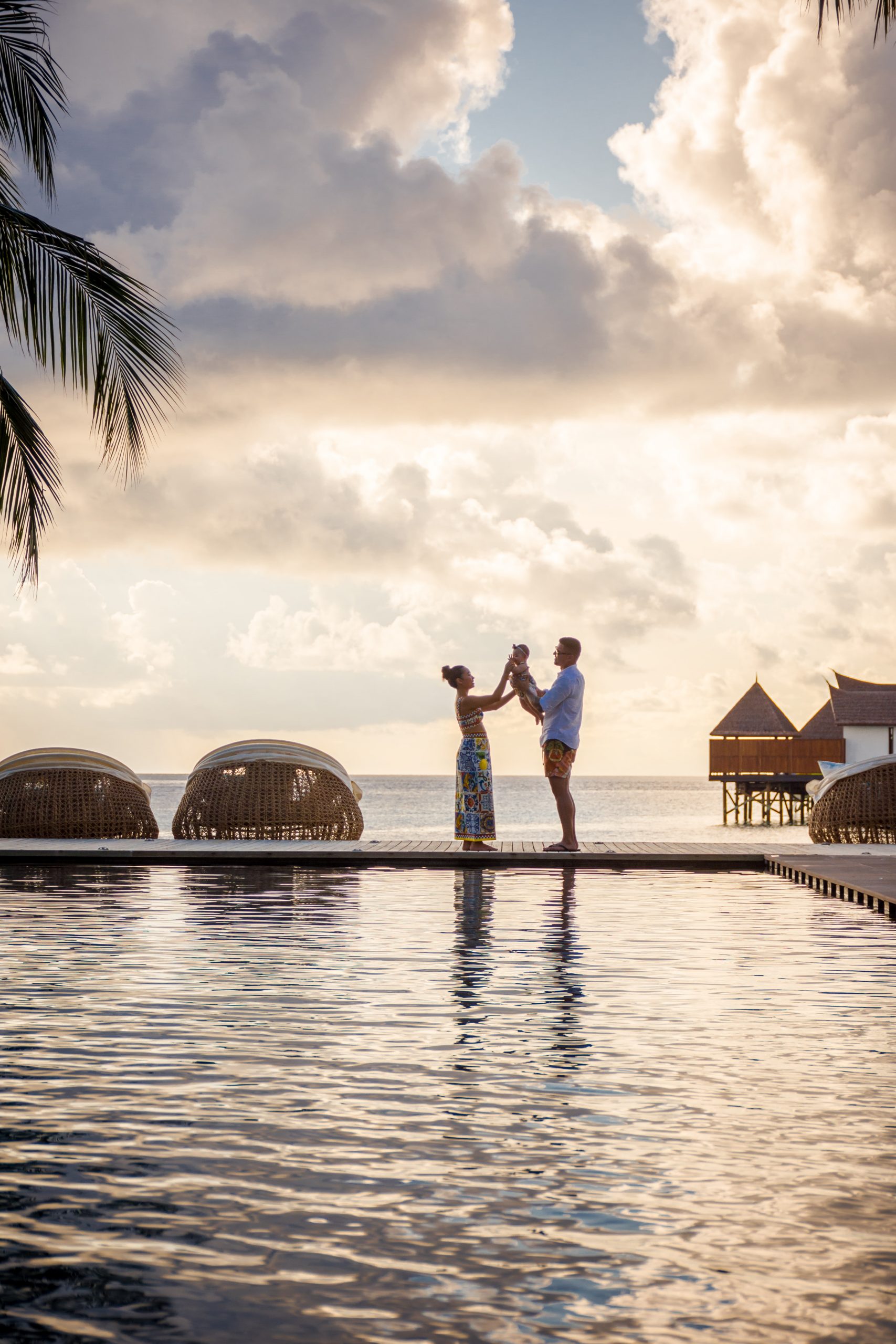 Young family vacationing in tropical, on the water hotel