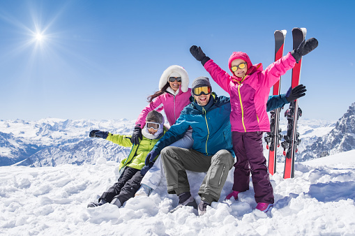 Family Skiing on Summit of Mountain
