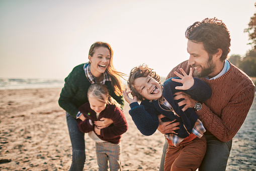 Close up of a young family enjoying time on a beach