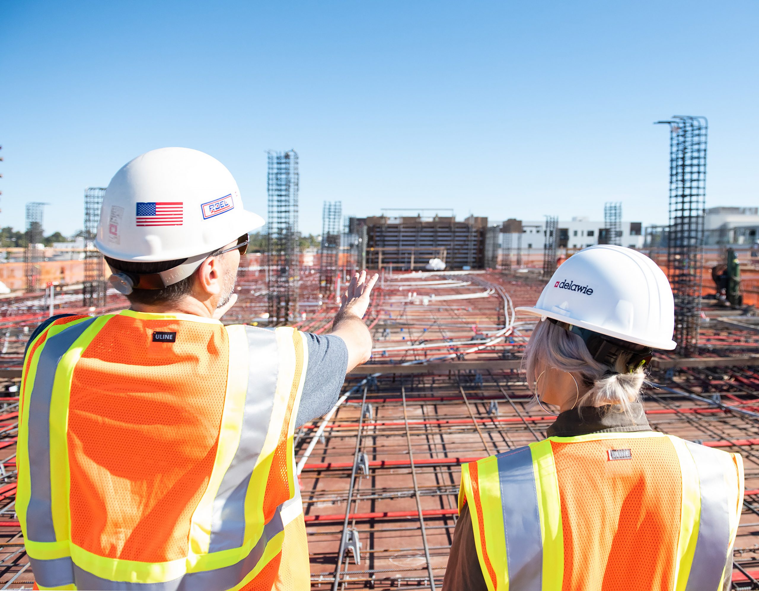 Man and Woman Construction Workers Overseeing Job Site