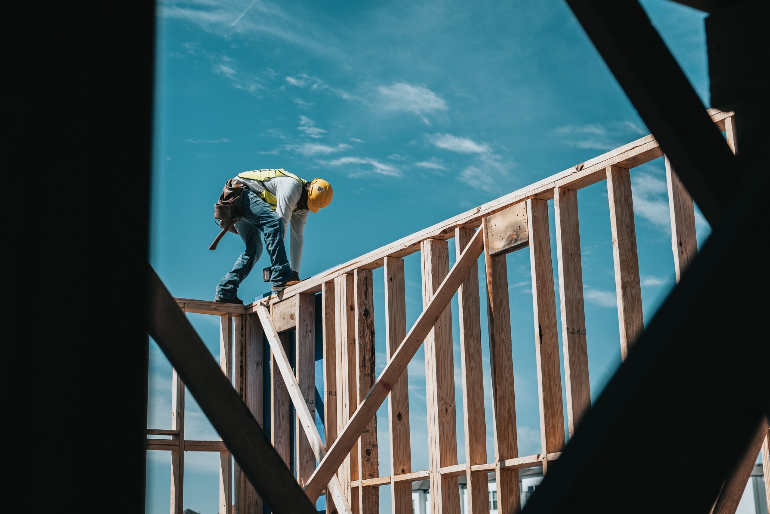 Construction Worker Standing On Top Of Beams