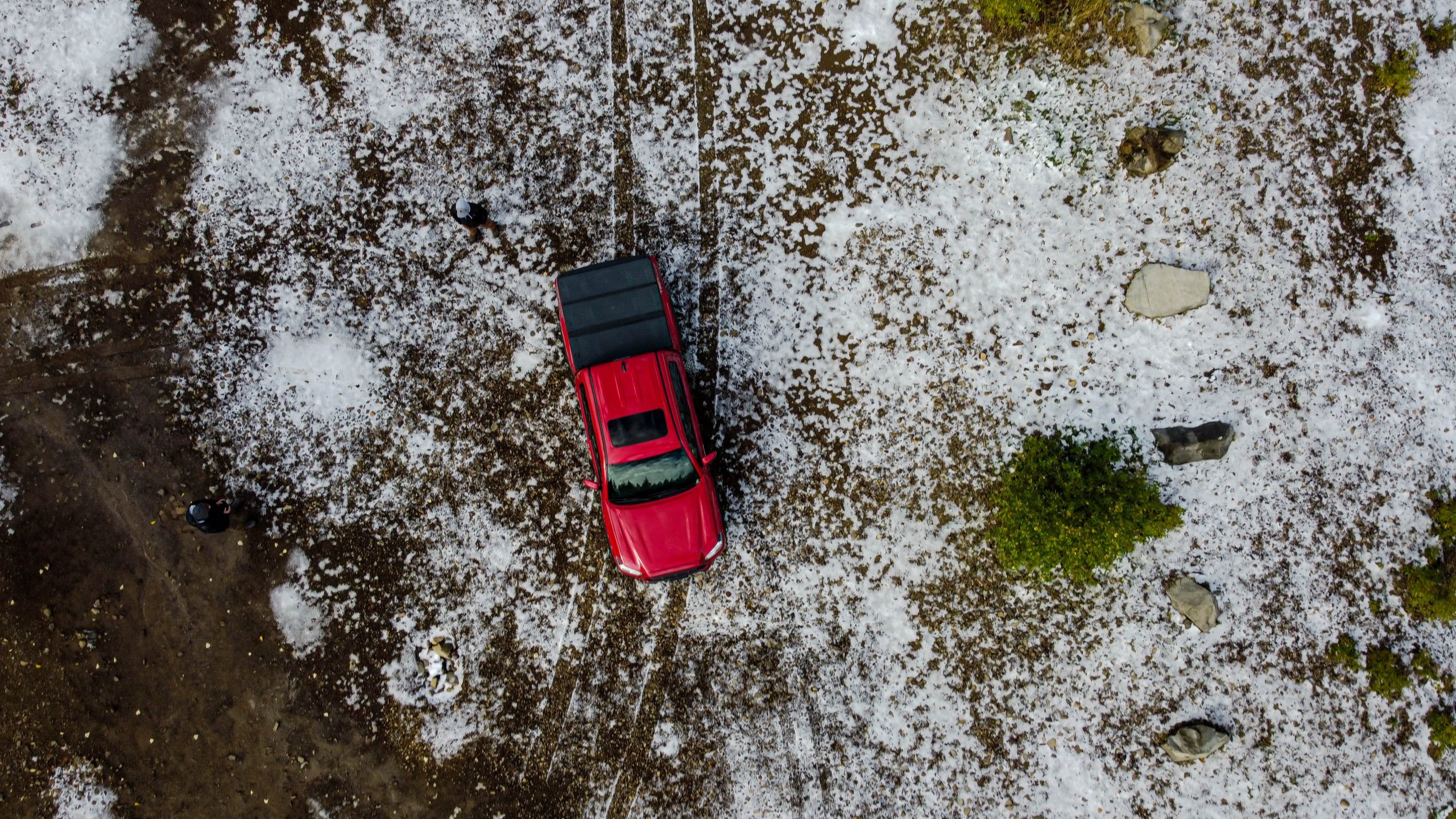Aerial View of Red Truck Driving Through Hail 