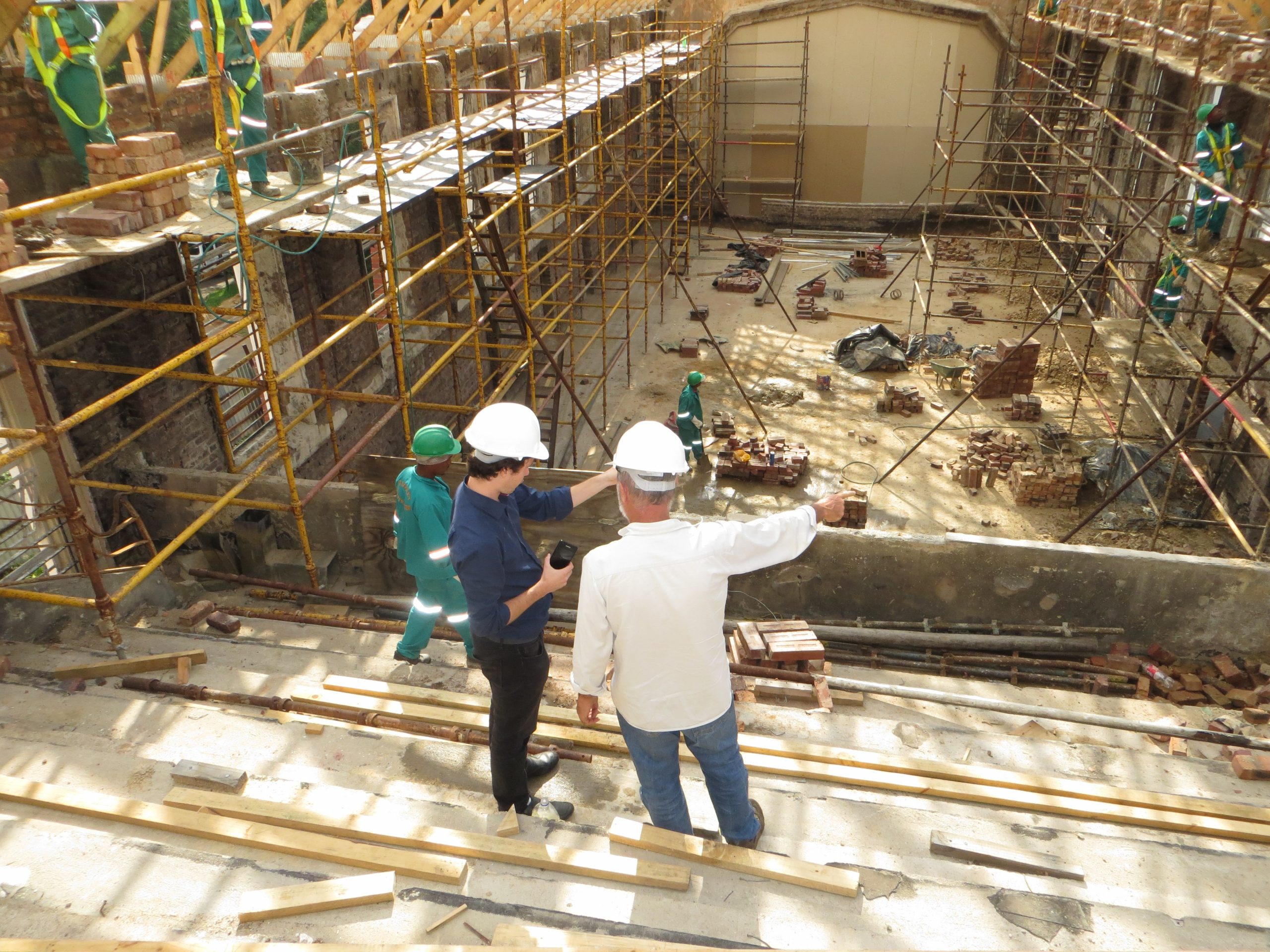 Two Construction Workers Overseeing Job Site Two Construction Workers Overseeing Job Site