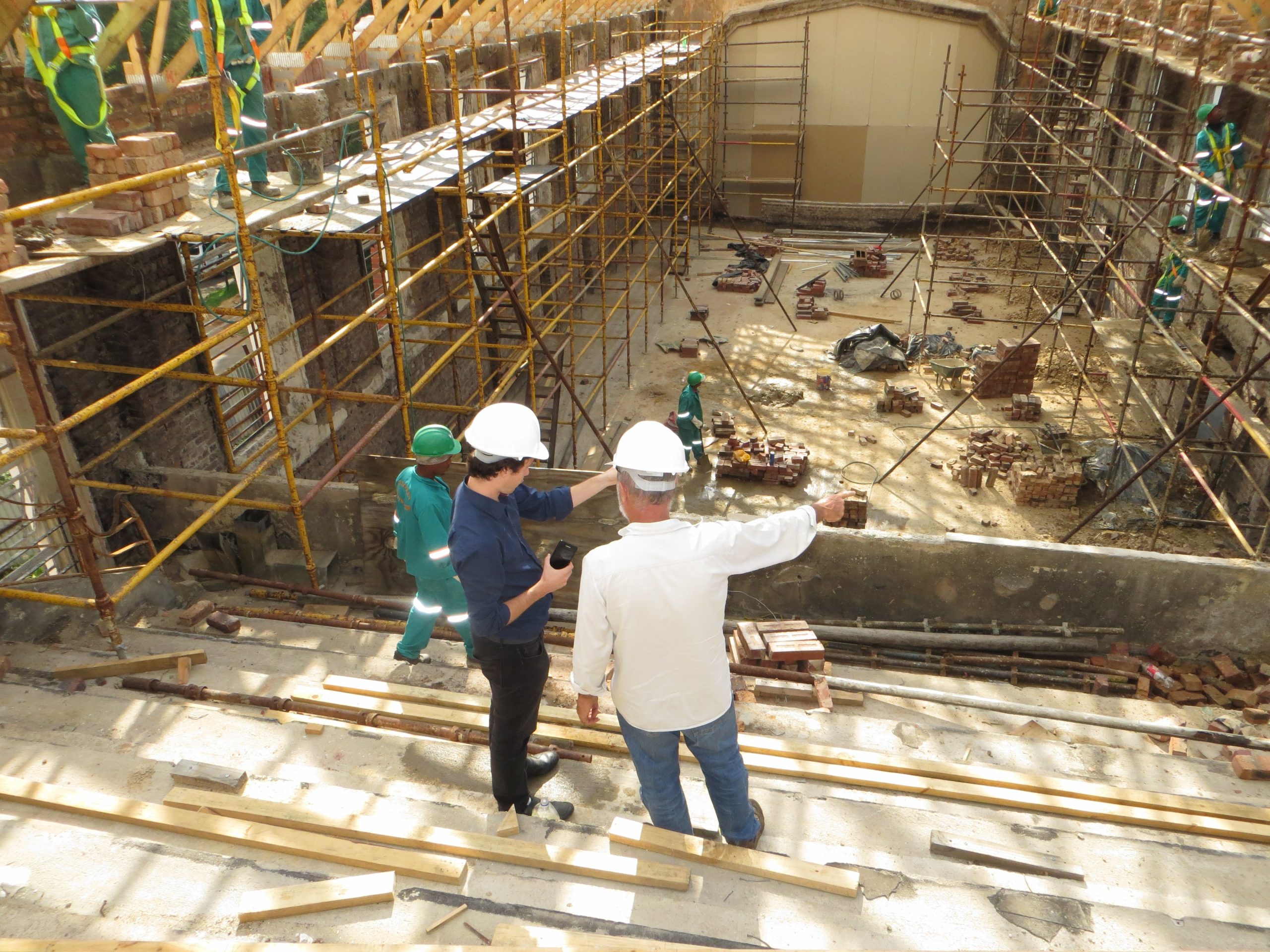 Two Construction Workers Overseeing Job Site