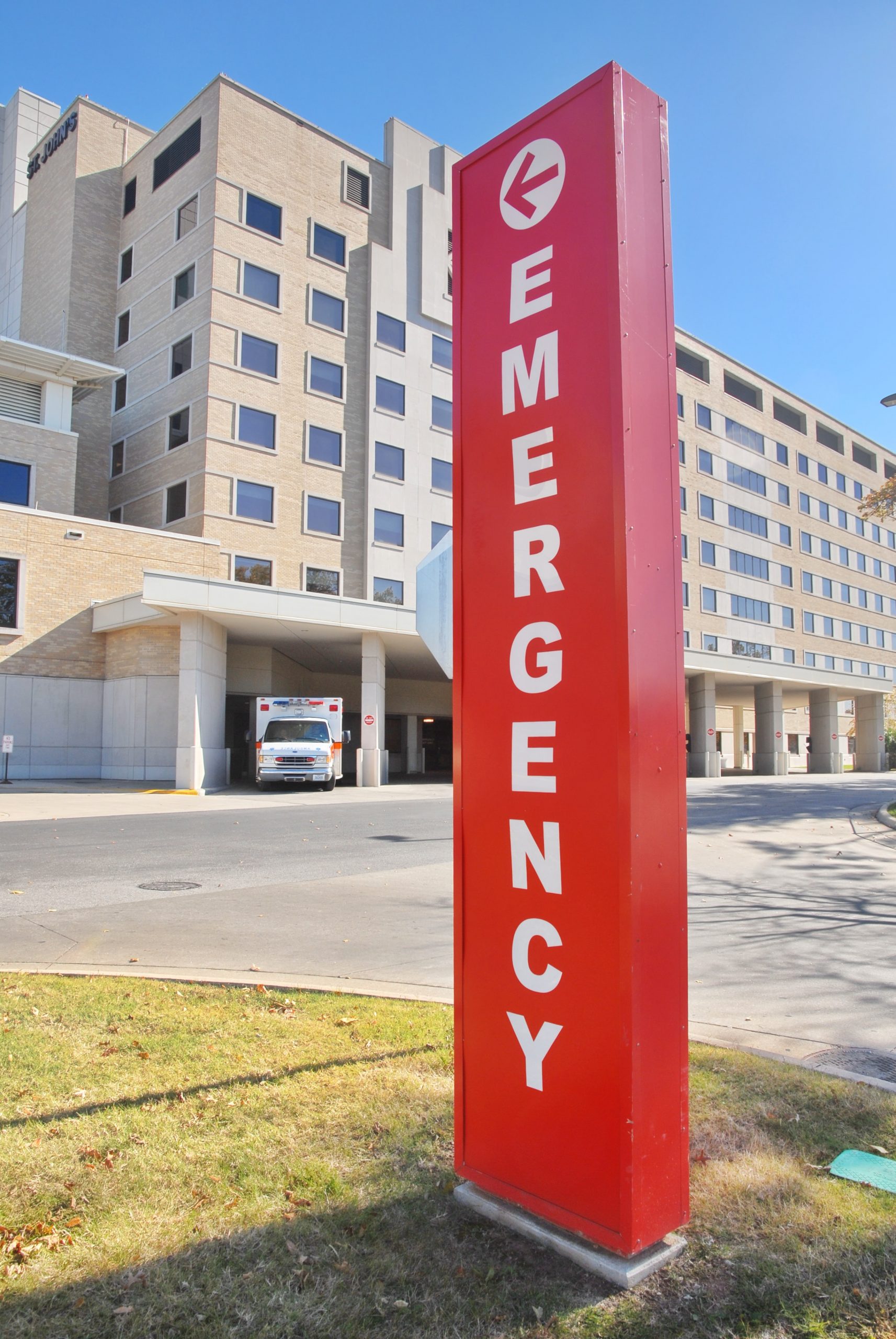 Tall Red Emergency Sign In Front Of Hospital