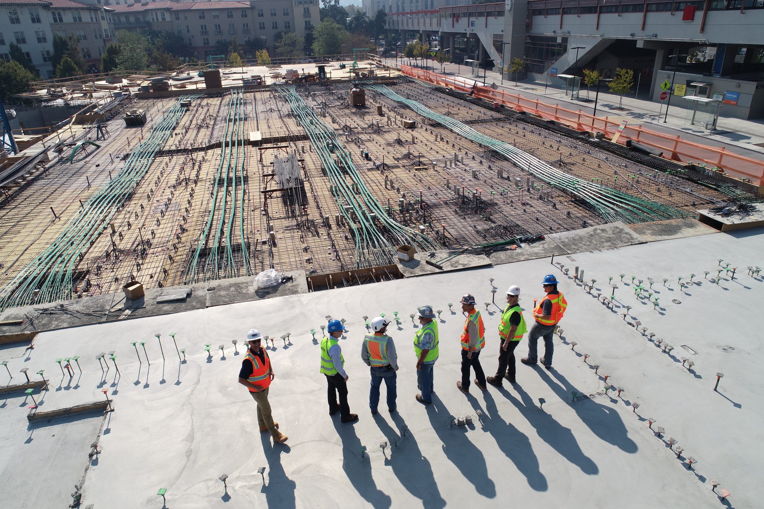 Seven Construction Workers Overseeing Job Site