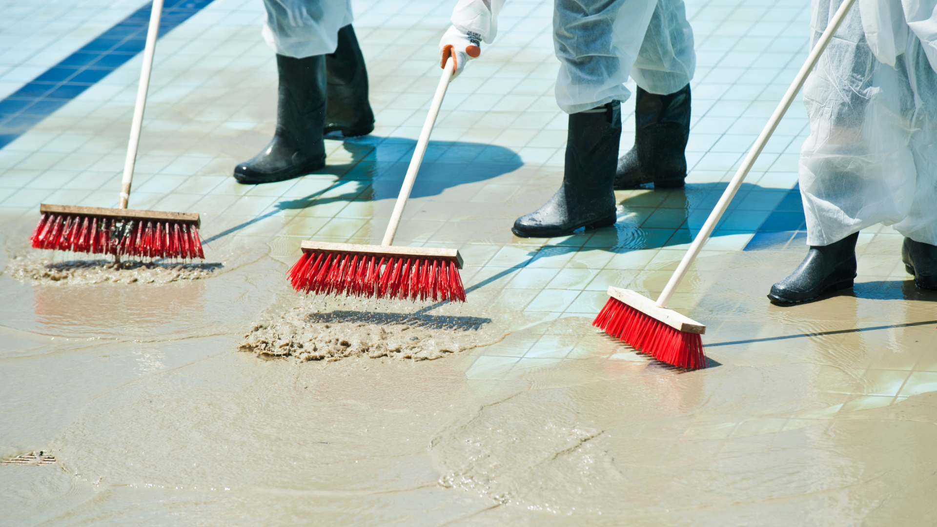 3 Clean Up Crew Members Sweeping Out Flood Water 3 Clean Up Crew Members Sweeping Out Flood Water