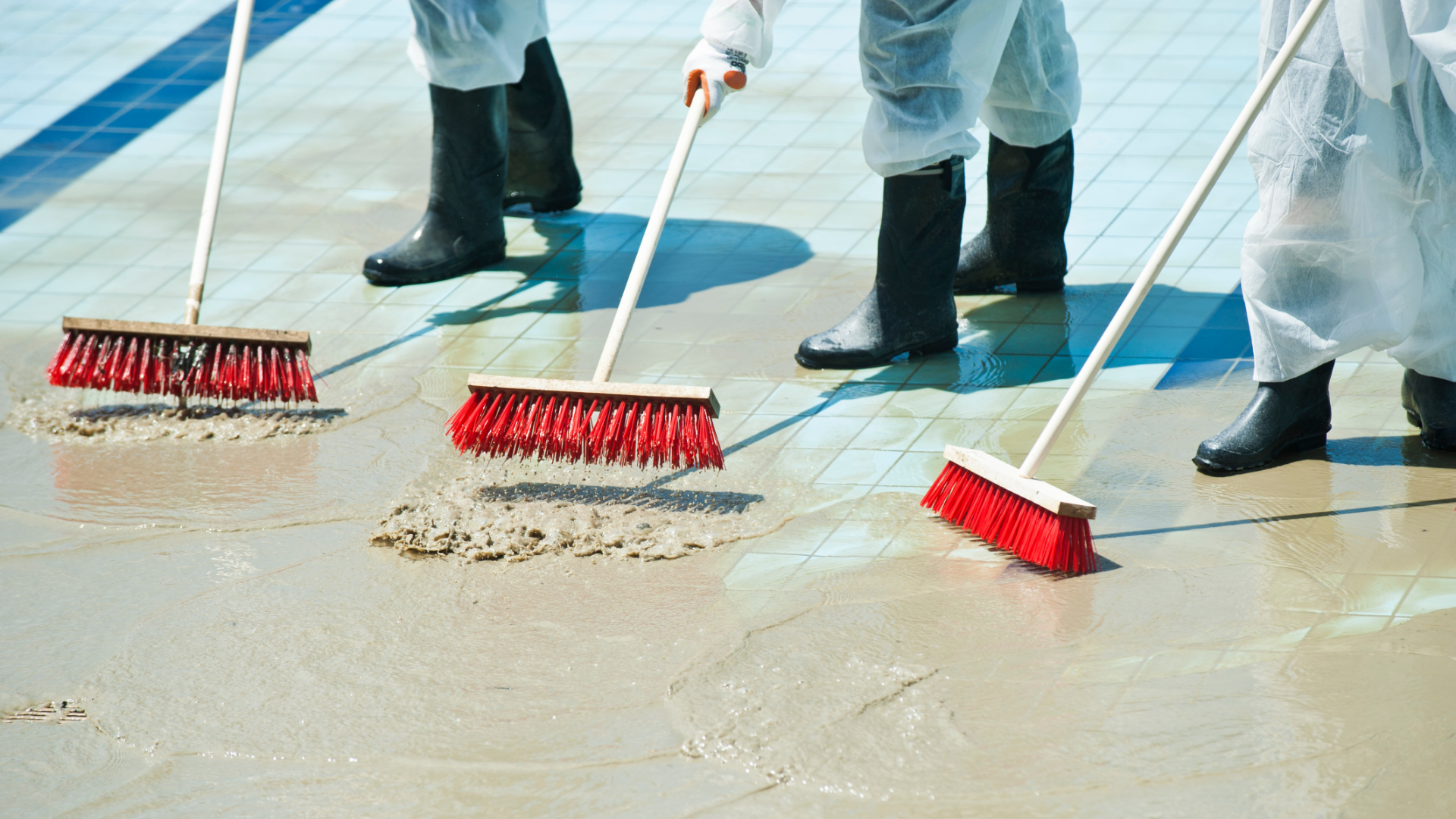 3 Clean Up Crew Members Sweeping Out Flood Water