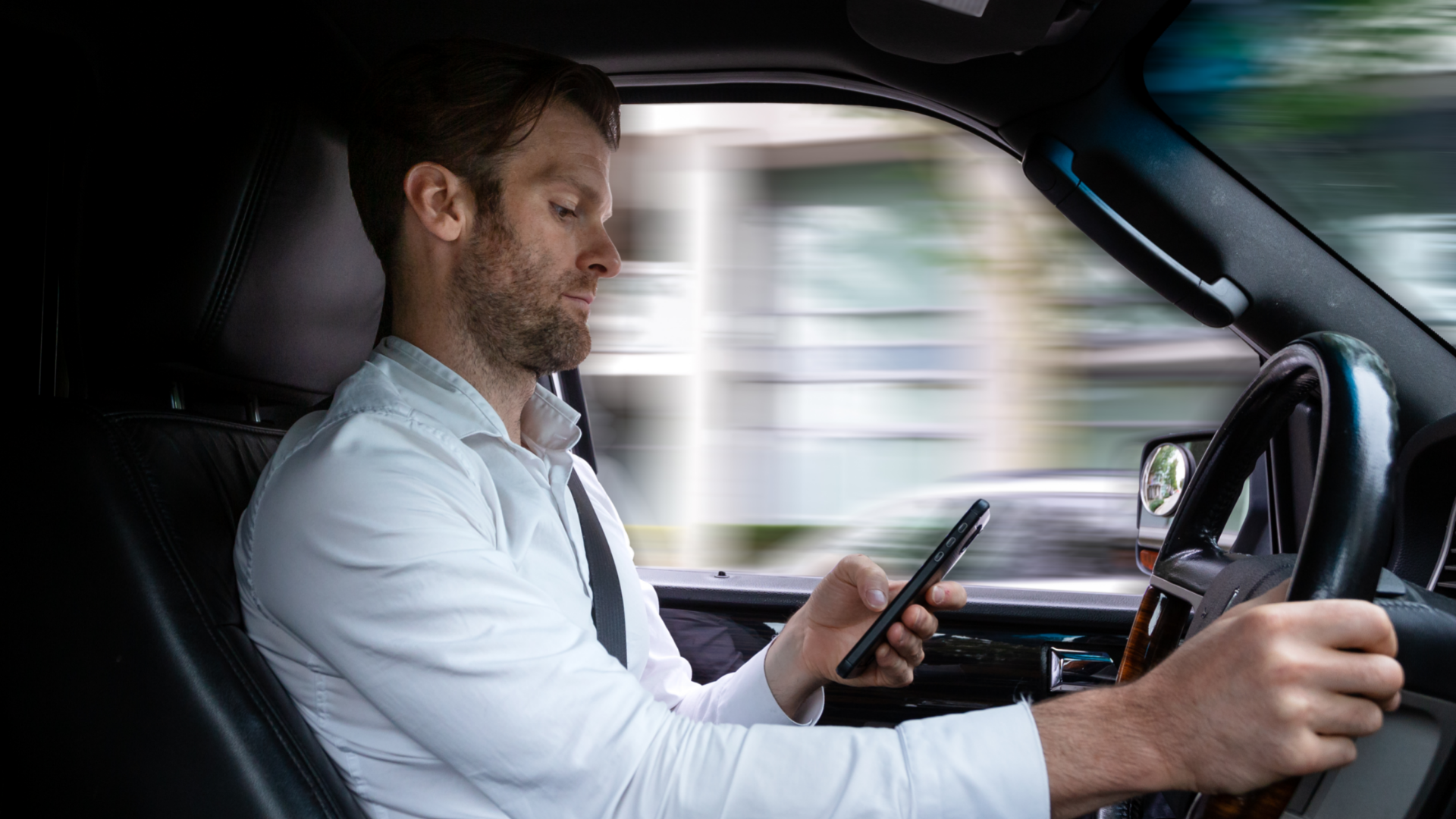 Man Distracted Driving While Using Cell Phone