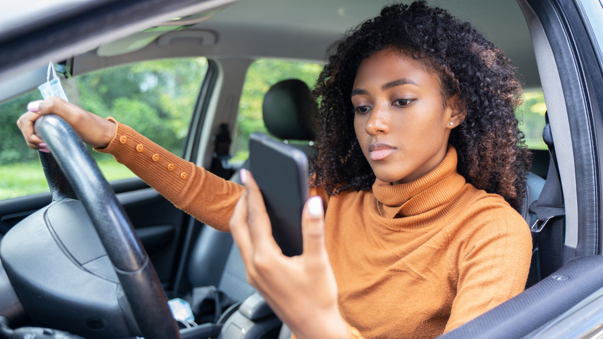 Woman Distracted Driving by Looking at Cell Phone