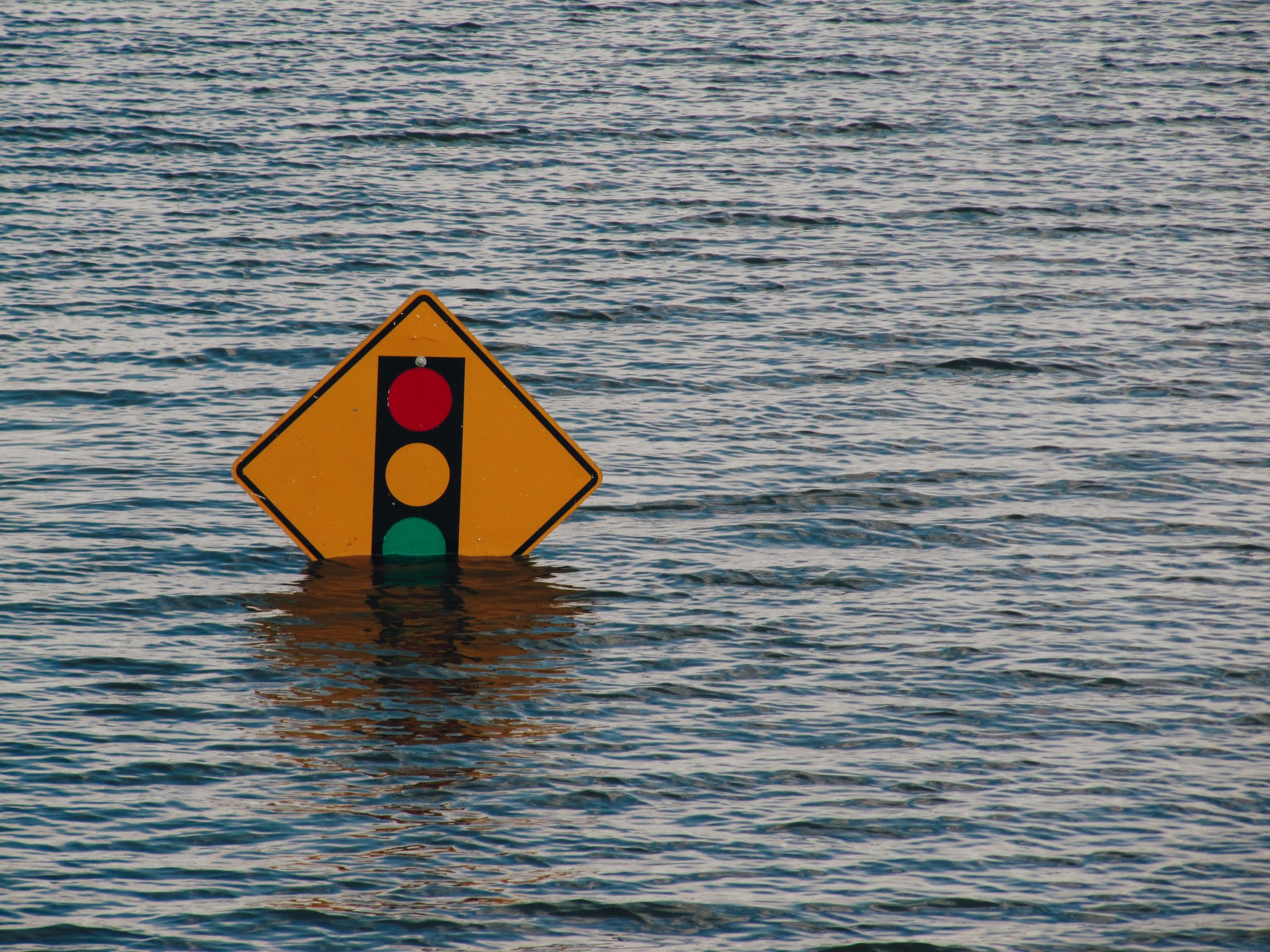 Road Sign Halfway Underwater in Flood Road Sign Halfway Underwater in Flood
