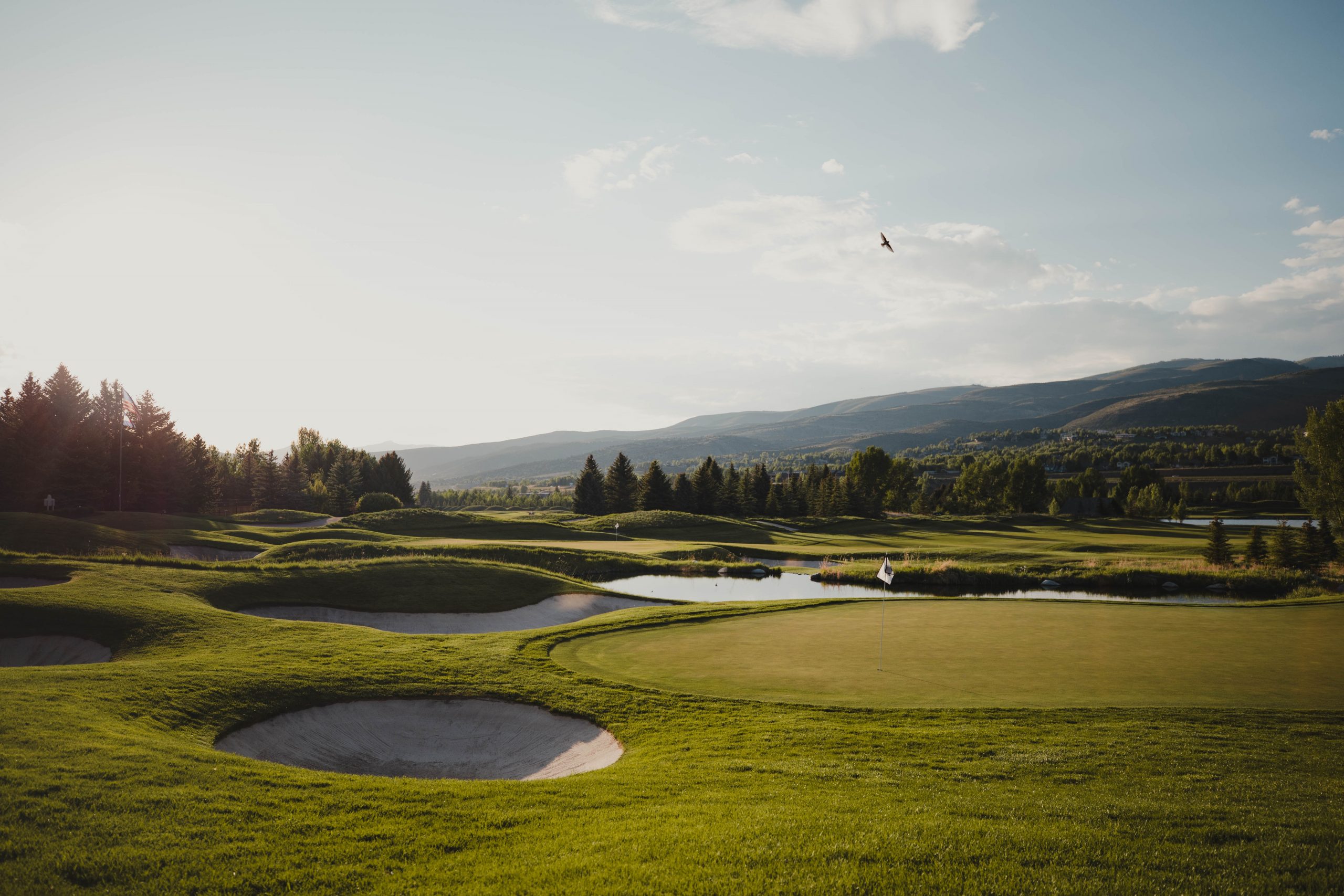 Overview of Golf Course with Green Hills In Background