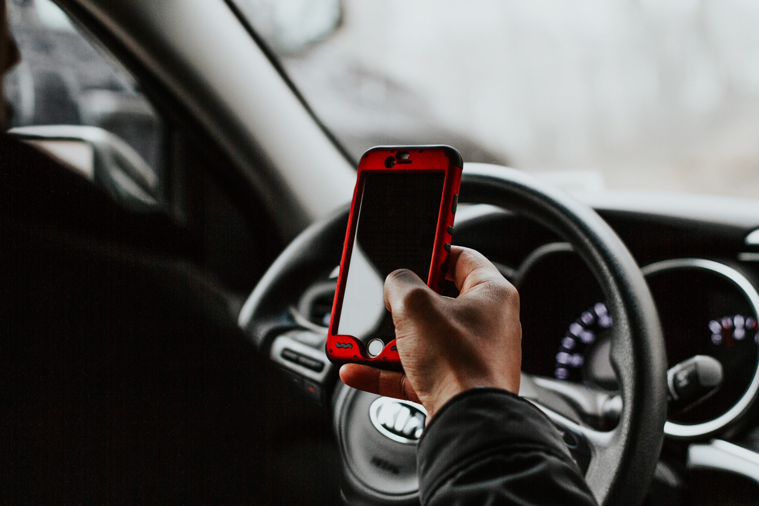 Person Holding Phone While Driving