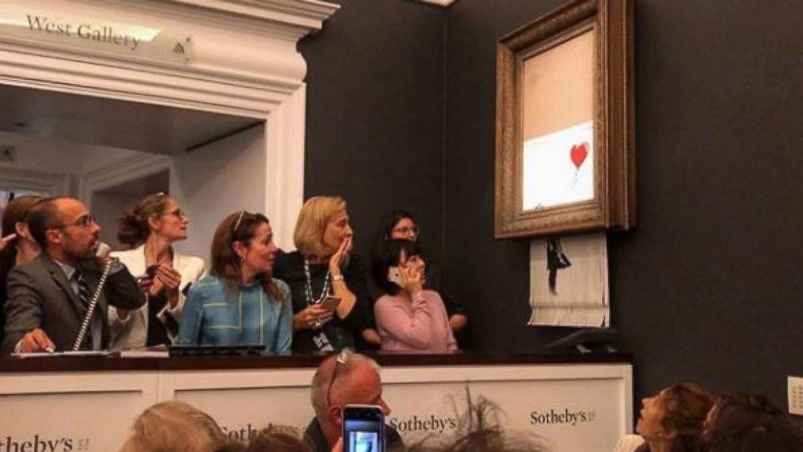 Onlookers Observe Banksy Art Piece Being Shredded