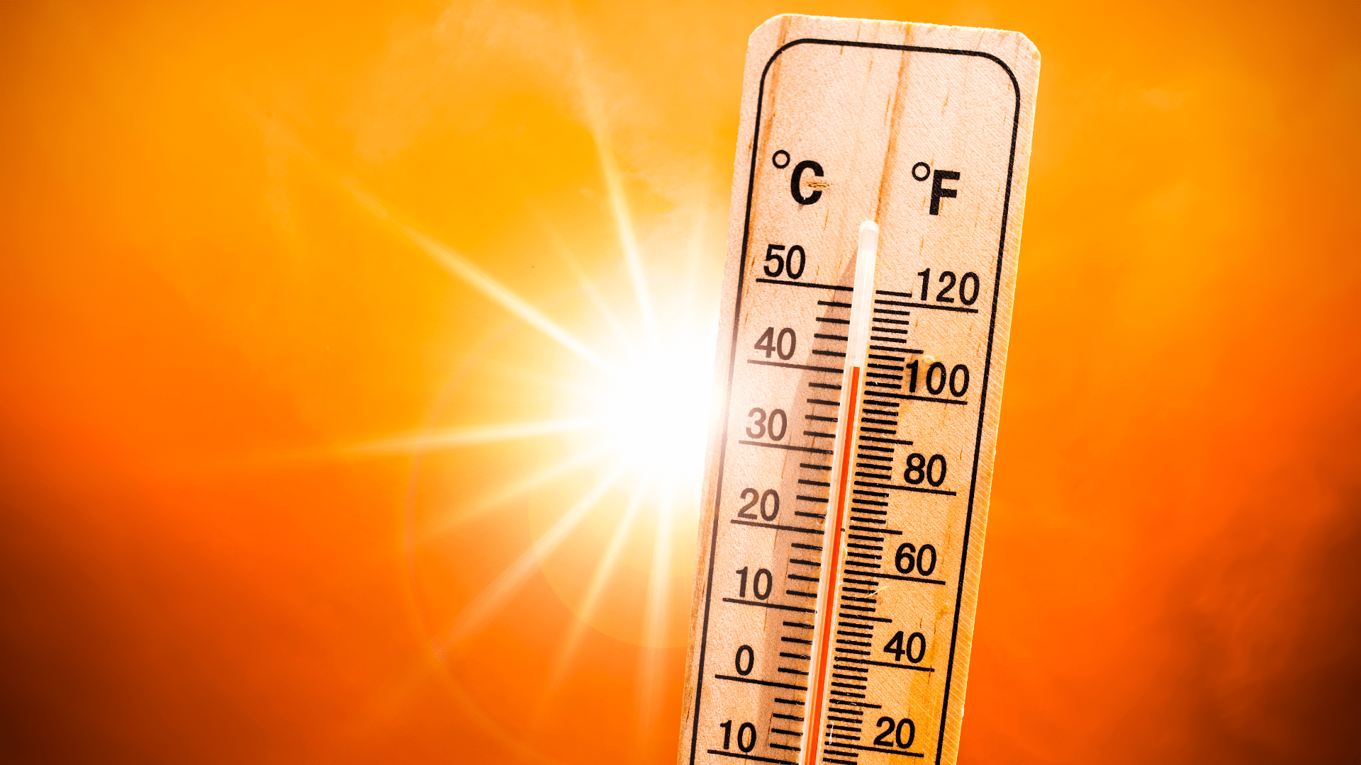 Thermometer with Sun in Background
