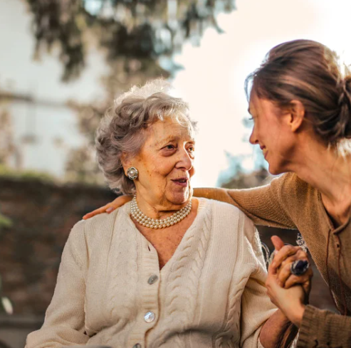 Middle Aged Woman Hugging Her Elderly Mother Middle Aged Woman Hugging Her Elderly Mother