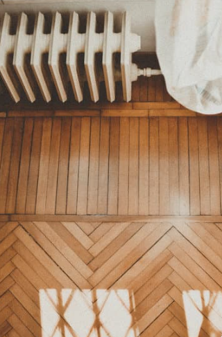 Chevron and Striped Patterned Hard Wood Floors and Radiator 
