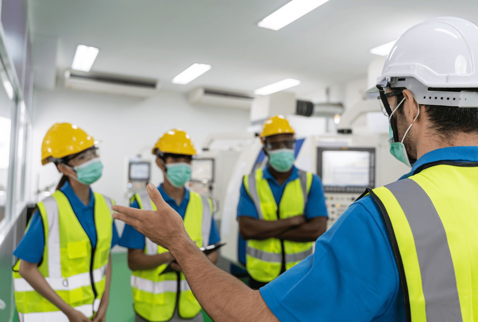 Boss Instructing Employees, All Wearing PPE Equipment Boss Instructing Employees, All Wearing PPE Equipment