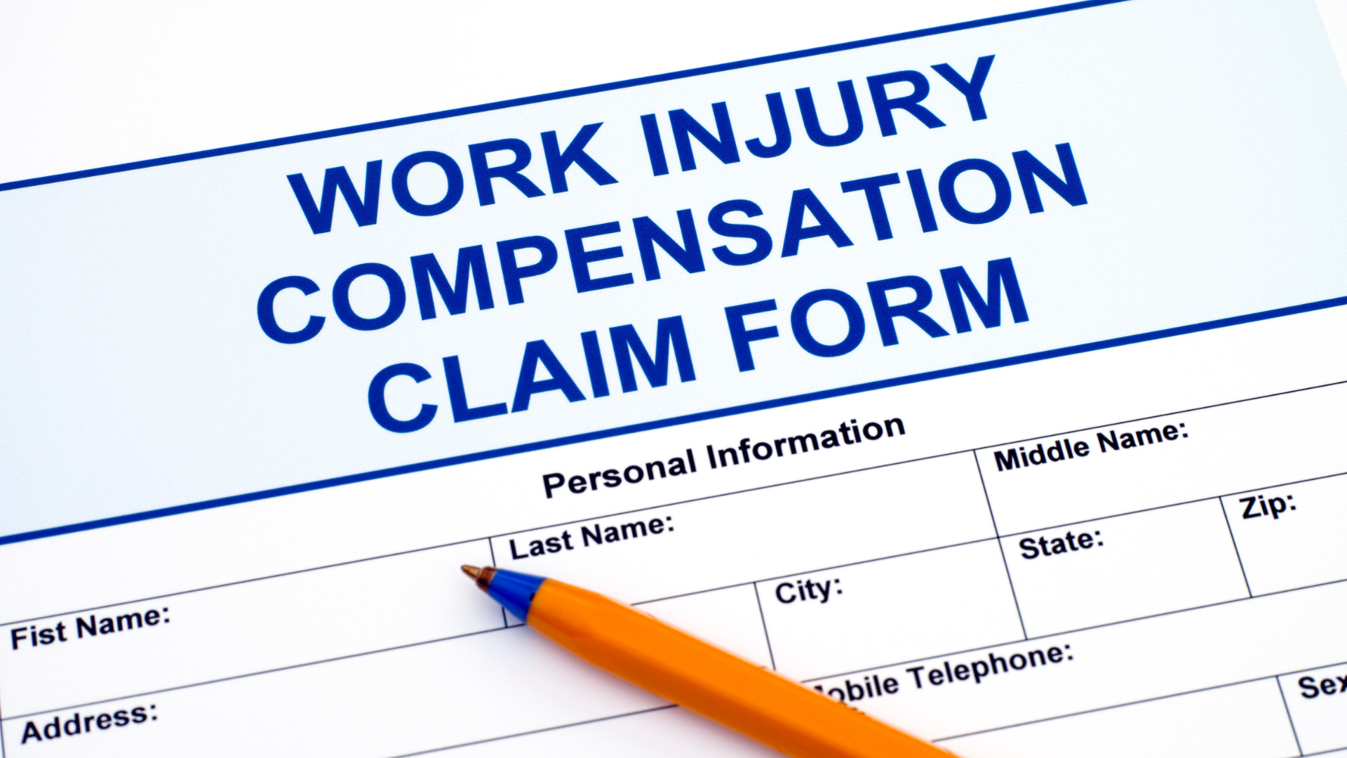 Workers Compensation Form in Blue Ink with Orange and Blue Pen on Top Workers Compensation Form in Blue Ink with Orange and Blue Pen on Top