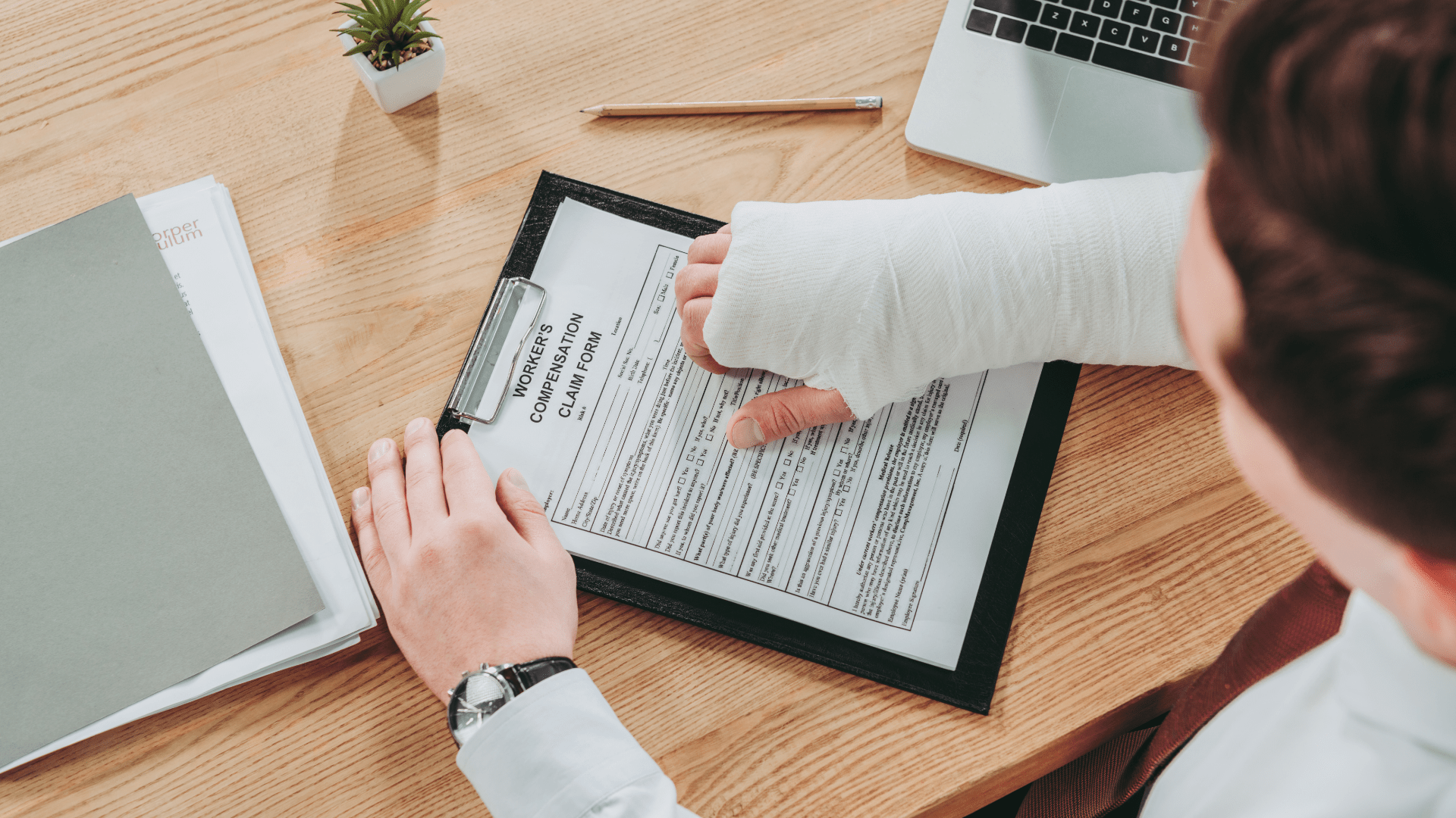Employee with Arm in Cast Reviewing Workers Comp Form Employee with Arm in Cast Reviewing Workers Comp Form