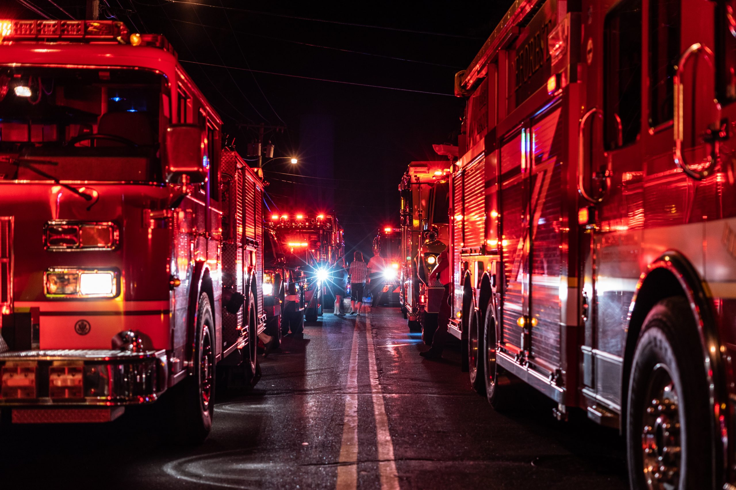 Line of Firetrucks on Either Side of Road