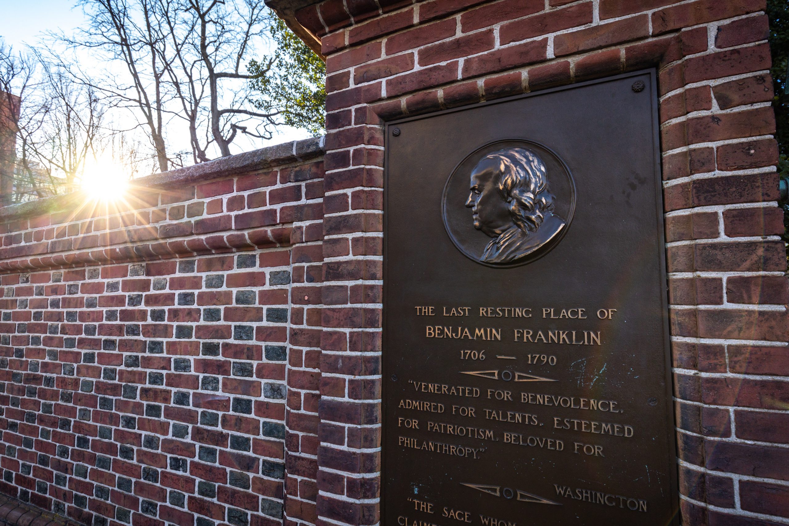 Benjamin Franklin Historical Plaque on Brick Wall at Sunset