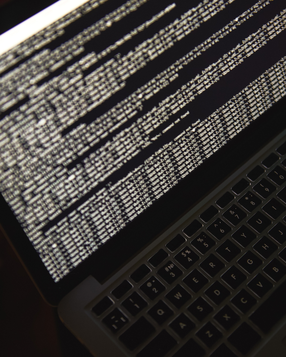 Hacking server. Close up photo of laptop screen with binary code. Cyber attack Tower Street Insurance Loss Control OSHA Safe and Sound Week