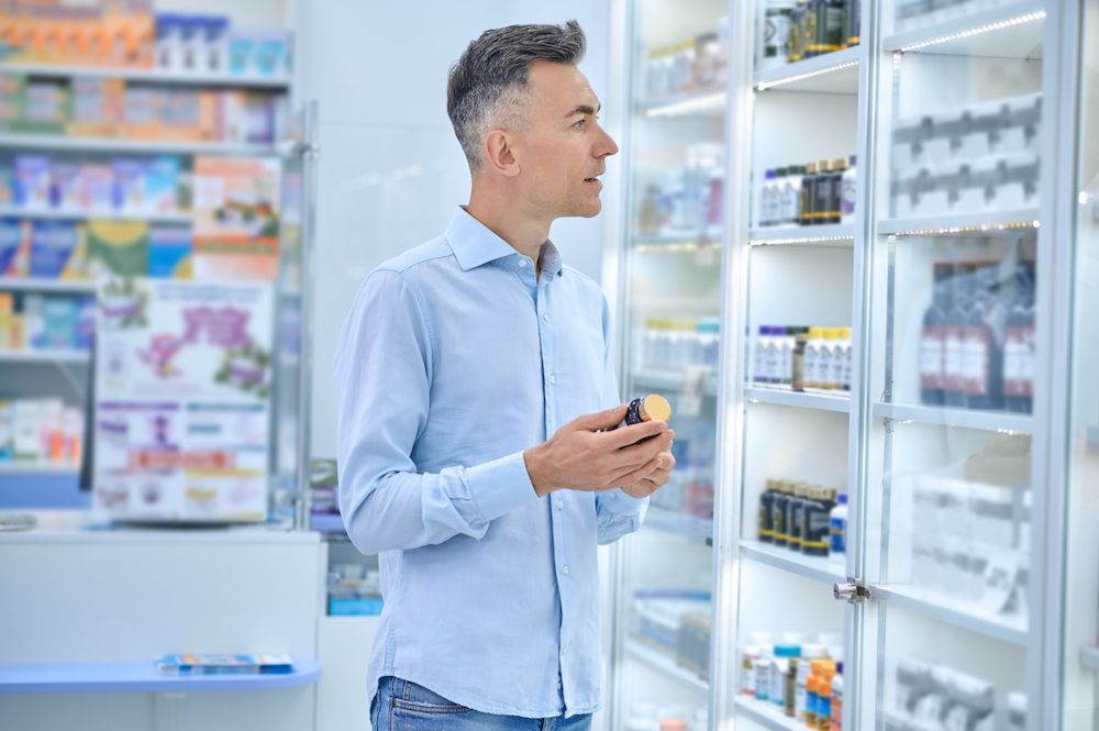 A man choosing medicines in a drugstore Tower Street Insurance Loss Control OSHA Safe and Sound Week