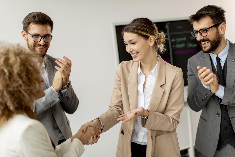 Group of young business people making a deal at a meeting in the office Osha,Inspection,Worker,At,Construction,Site.,Building,Safety