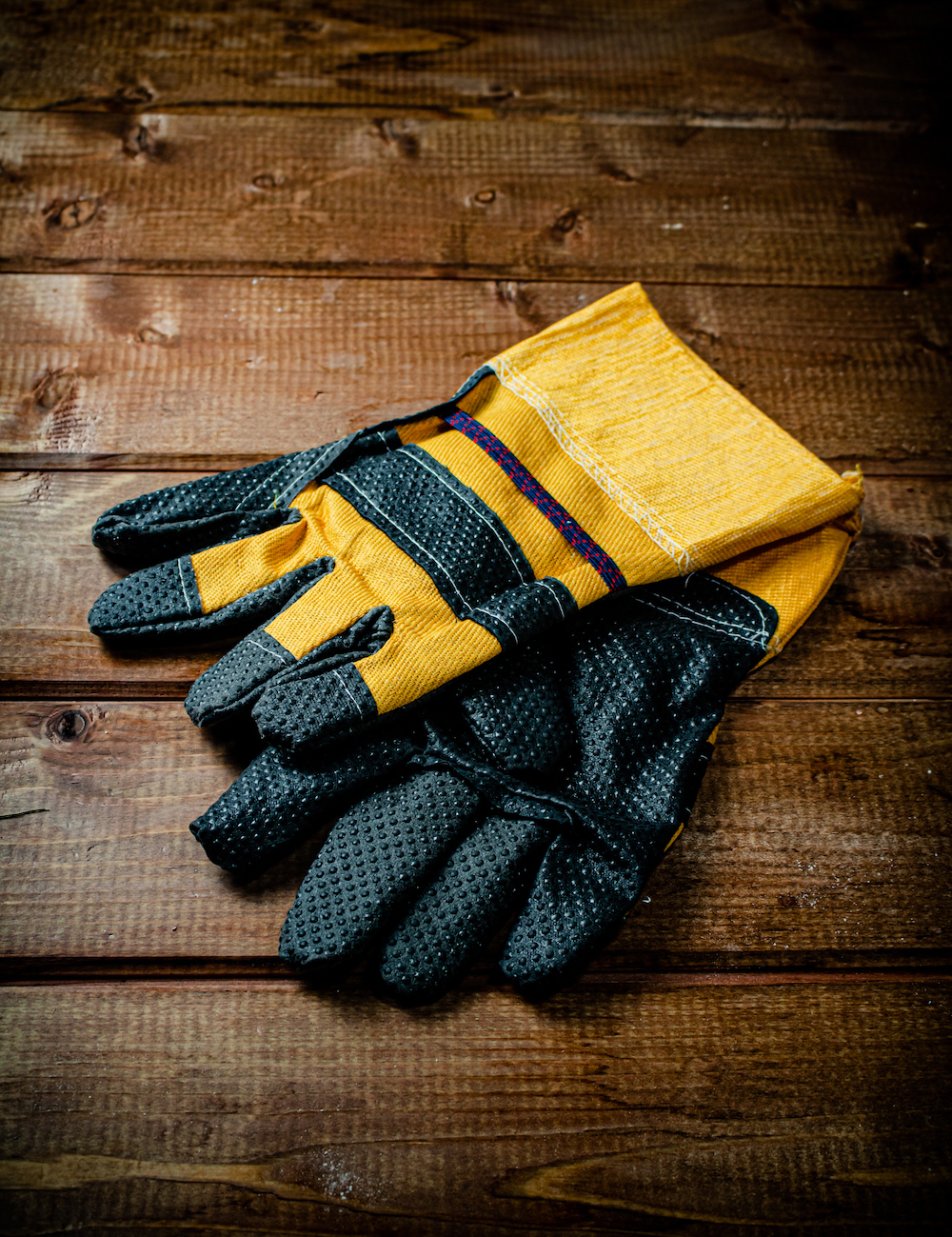 A pair of construction gloves on the table. Tower Street Insurance Loss Control OSHA Safe and Sound Week Safety and Health
