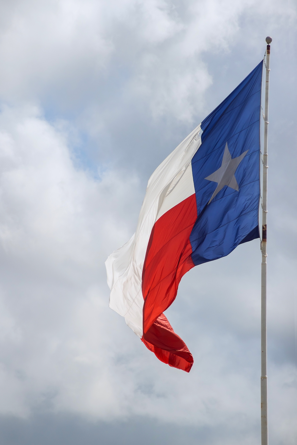 Rippled State Flag Star Flag of the State of Texas Tower Street Insurance Assisted Living Hospice Personal Care Memory
