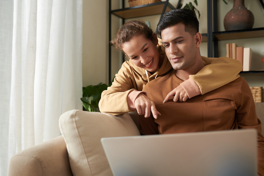 Young couple doing online shopping Tower Street Insurance Loss Control OSHA Safe and Sound Week